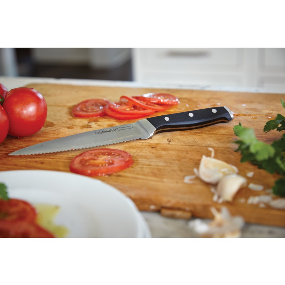 https://newellbrands.scene7.com/is/image/NewellRubbermaid/1924555-calphalon-classic-cutlery-self-sharpen-6-inch-serrated-utility-knife-tomato-in-use-5-1?wid=1000&hei=1000