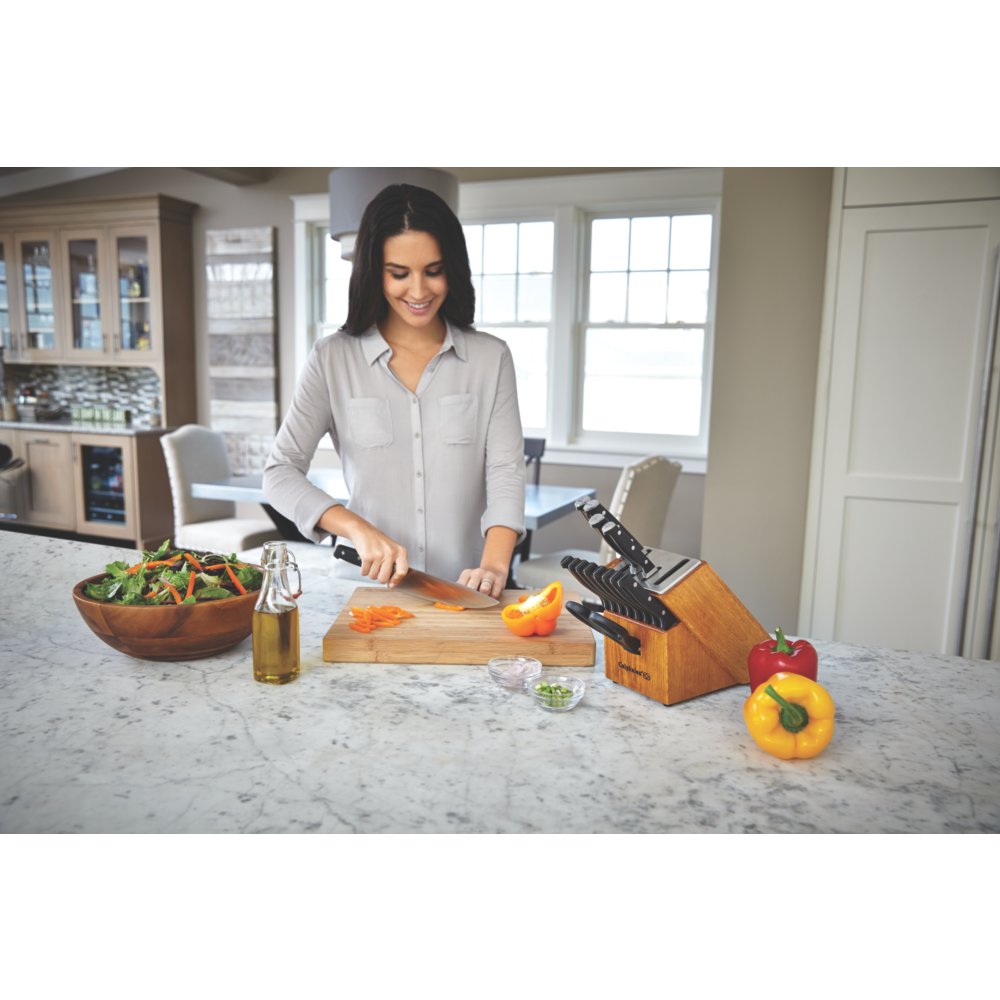 https://newellbrands.scene7.com/is/image/NewellRubbermaid/1932932-calphalon-classic-cutlery-self-sharpen-8-inch-chefs-knife-bell-pepper-in-use-2?wid=1000&hei=1000