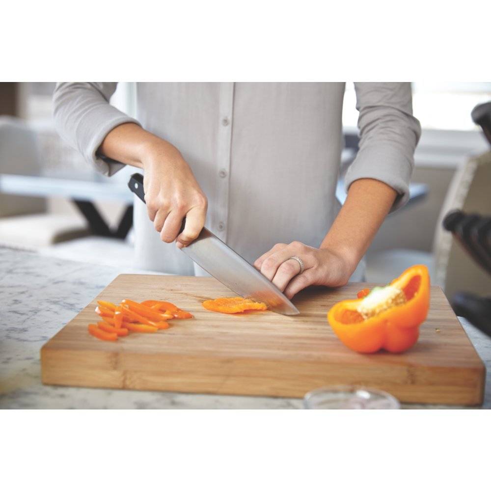 https://newellbrands.scene7.com/is/image/NewellRubbermaid/1932932-calphalon-classic-cutlery-self-sharpen-8-inch-chefs-knife-bell-pepper-in-use-6?wid=1000&hei=1000