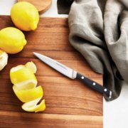 lemon peel with paring knife on cutting board image number 4