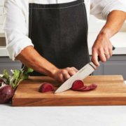 chefs knife cutting beet on cutting board image number 8