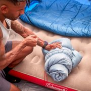 Camper rolling up Coleman sleeping bag image number 6