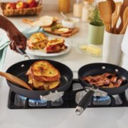 Person cooking with non-stick frying pans image number 3