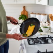 Person serving an omelet from a non-stick frying pan image number 2
