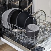 Non-stick cookware stacked in a dishwasher image number 2