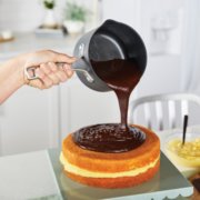 Person pouring chocolate sauce from a small non-stick saucepan image number 4