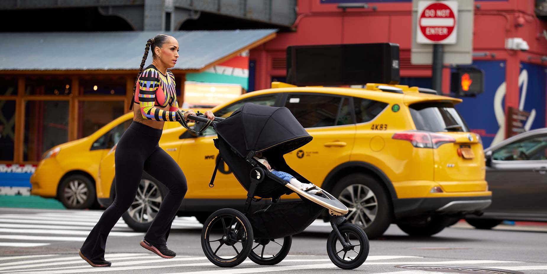 woman jogging with baby in jogging stroller