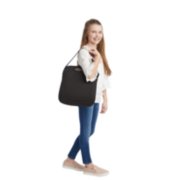 Tween girl carrying RightGuide portable seat belt trainer in carry bag image number 4