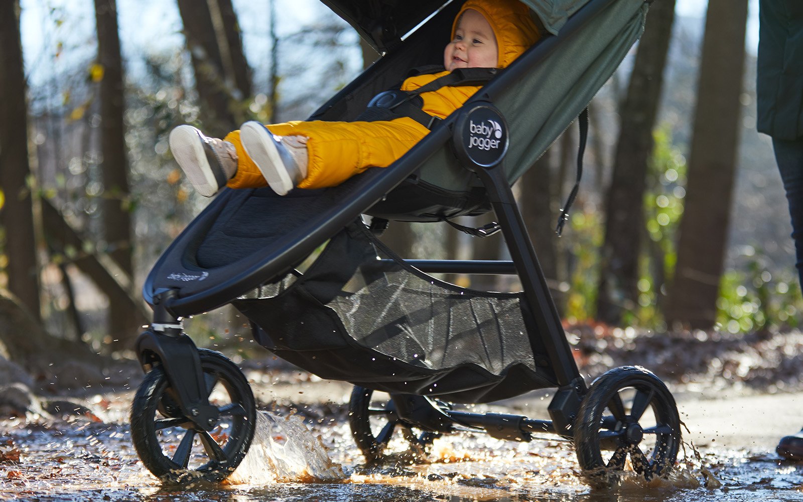woman jogging with child inside jogger stroller