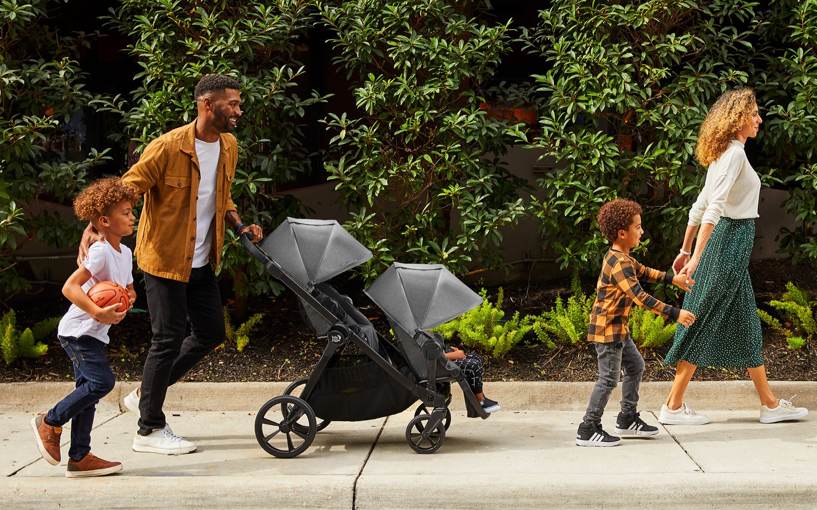 family out with two kids inside city sights stroller
