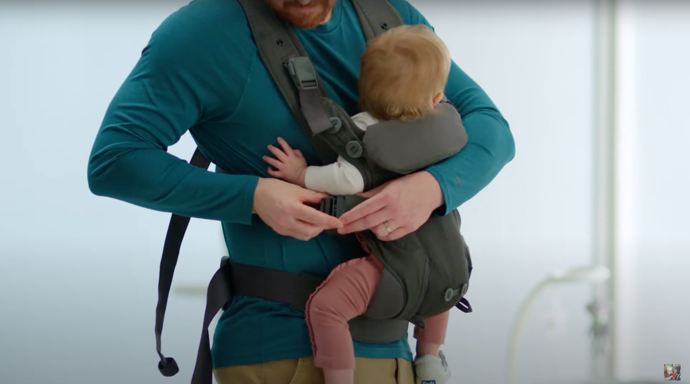 baby being secured inside carrier