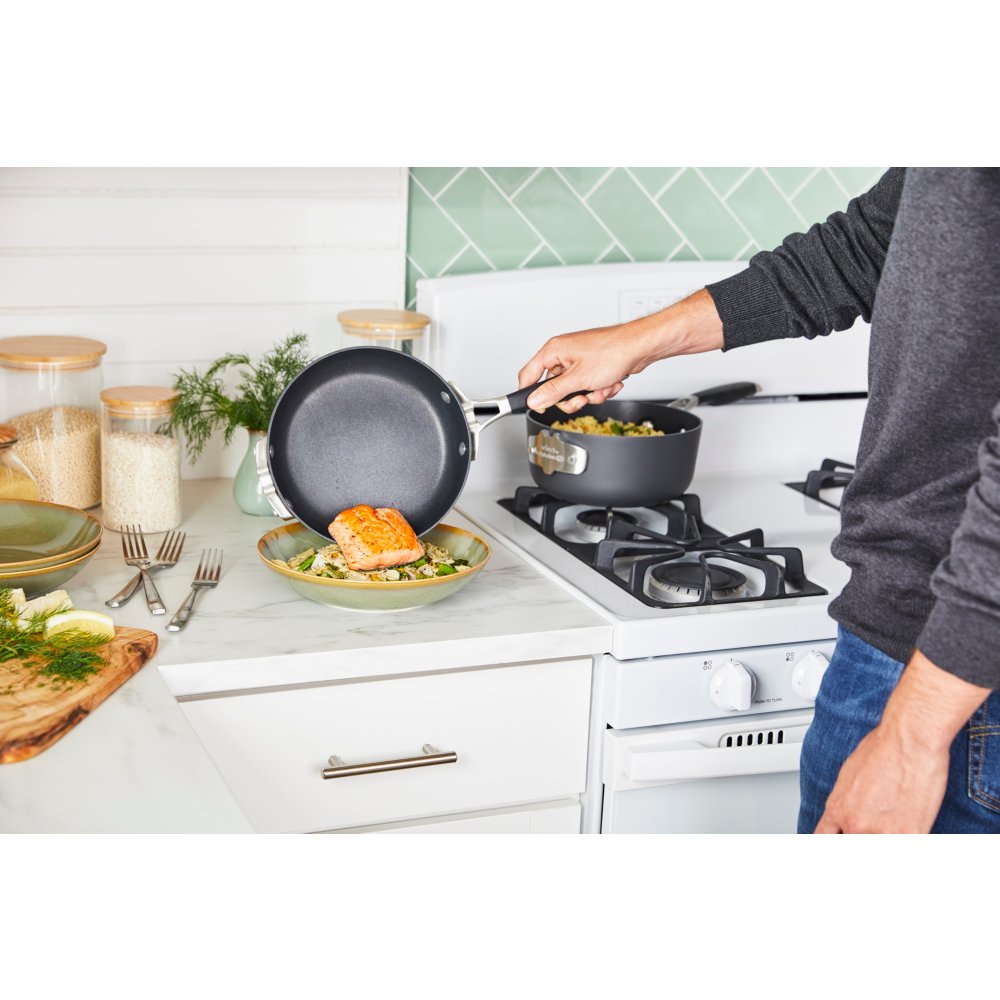 https://newellbrands.scene7.com/is/image/NewellRubbermaid/Calphalon-Cookware-Good-Tier-Nonstick-Select-SpaceSaving-FryPan-high-angle-with-talent-with-food-1?wid=1000&hei=1000