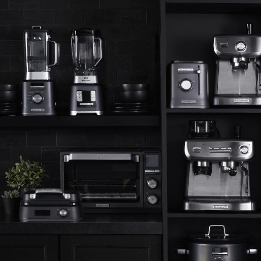 Small appliances, including an espresso machine, countertop oven, blender, and a waffle maker