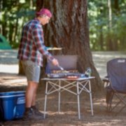 man using tabletop grill outside image number 7