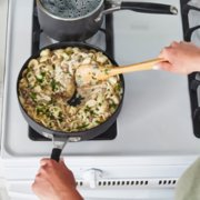 Person cooking food on stovetop image number 6