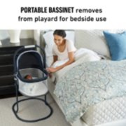 portable bassinet set up next to bed image number 2