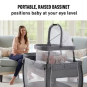 portable raised bassinet and toddler playard in living room image number 2