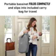 Portable bassinet folded up with mother carrying over shoulder holding baby image number 4