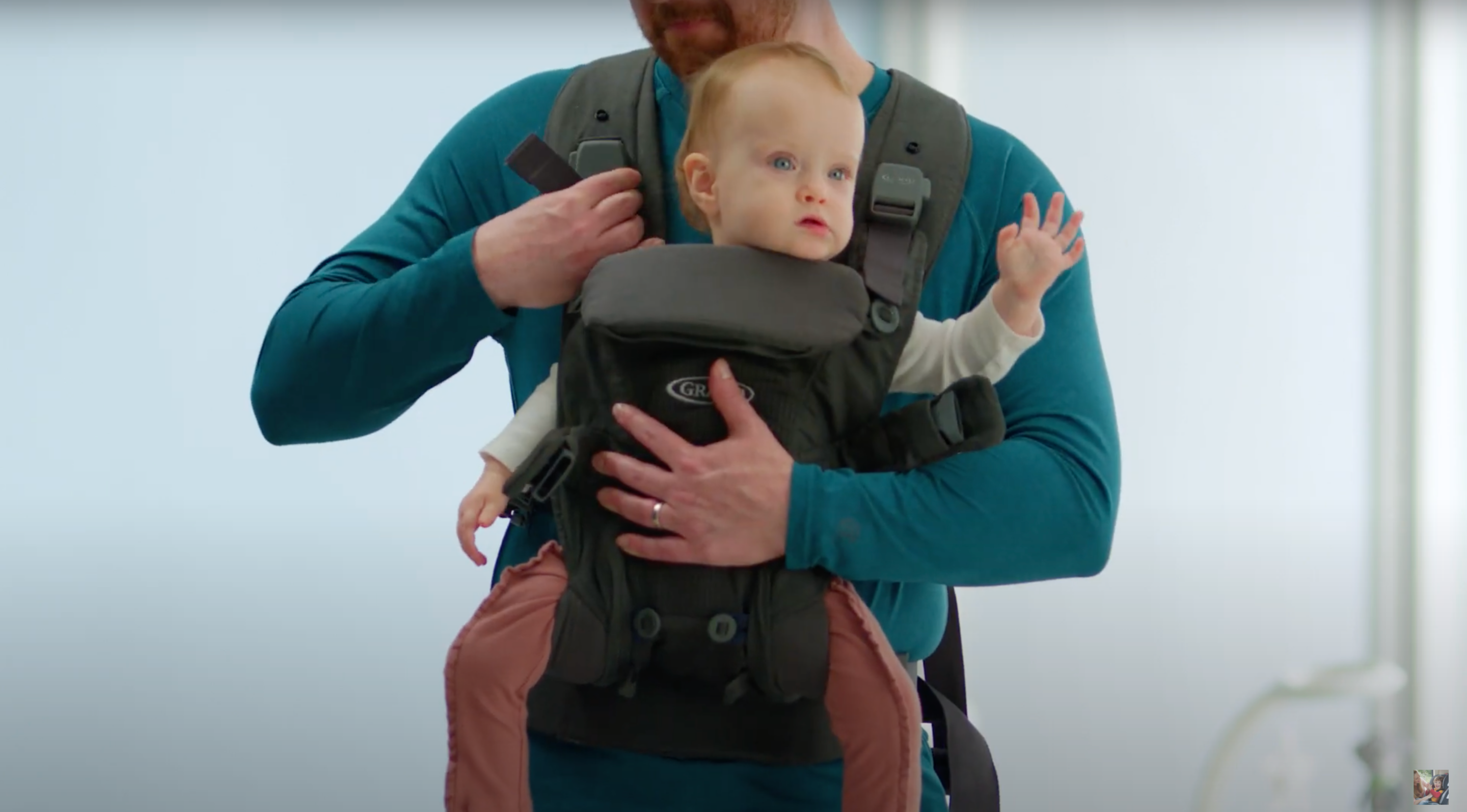 baby being secured inside carrier