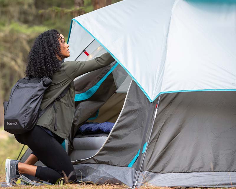 Woman setting up a tent