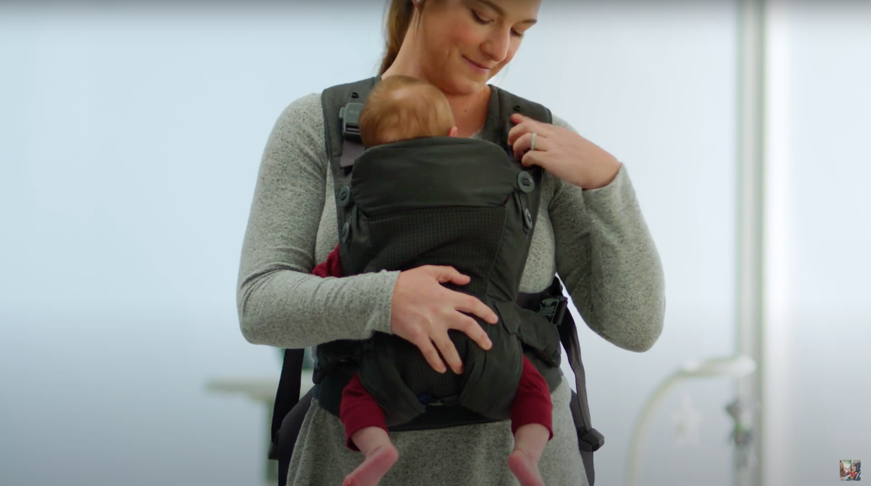 baby being secured inside carrier