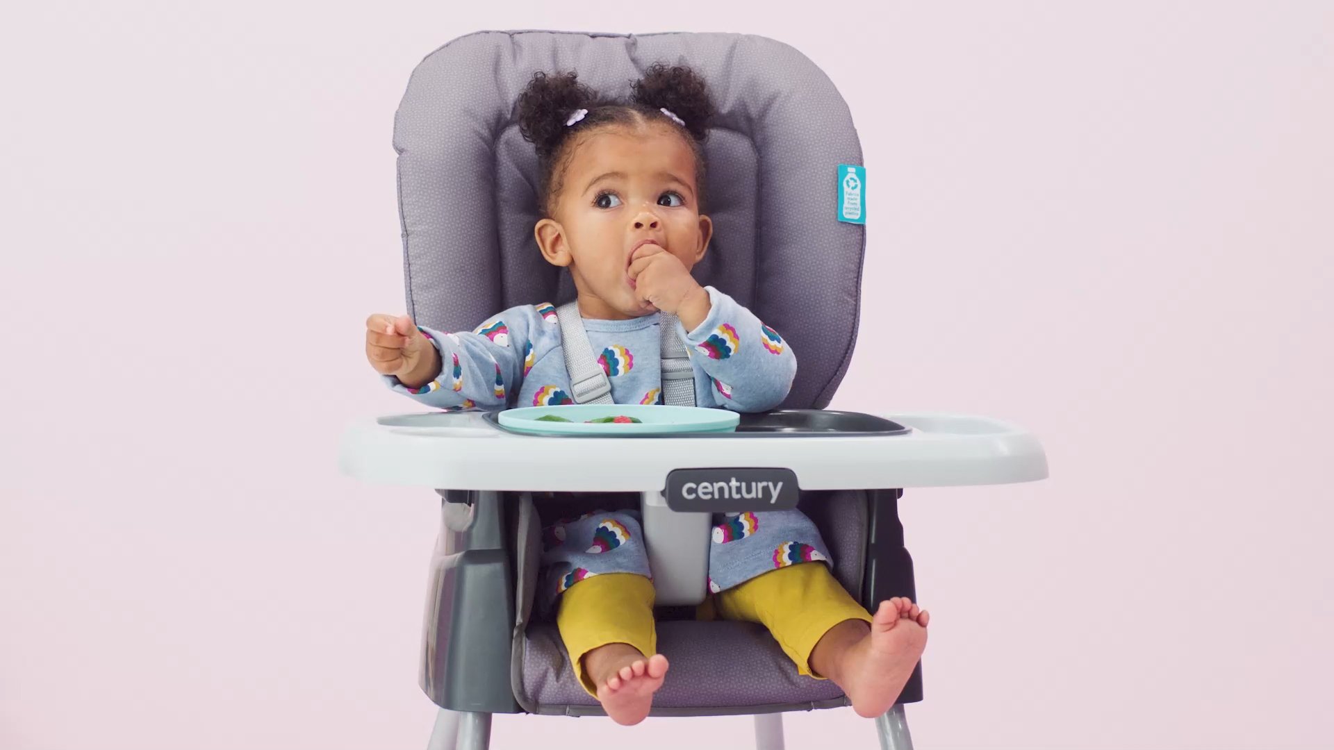 infant eating food in high chair