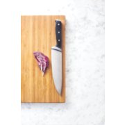 chefs knife on cutting board with radicchio image number 4