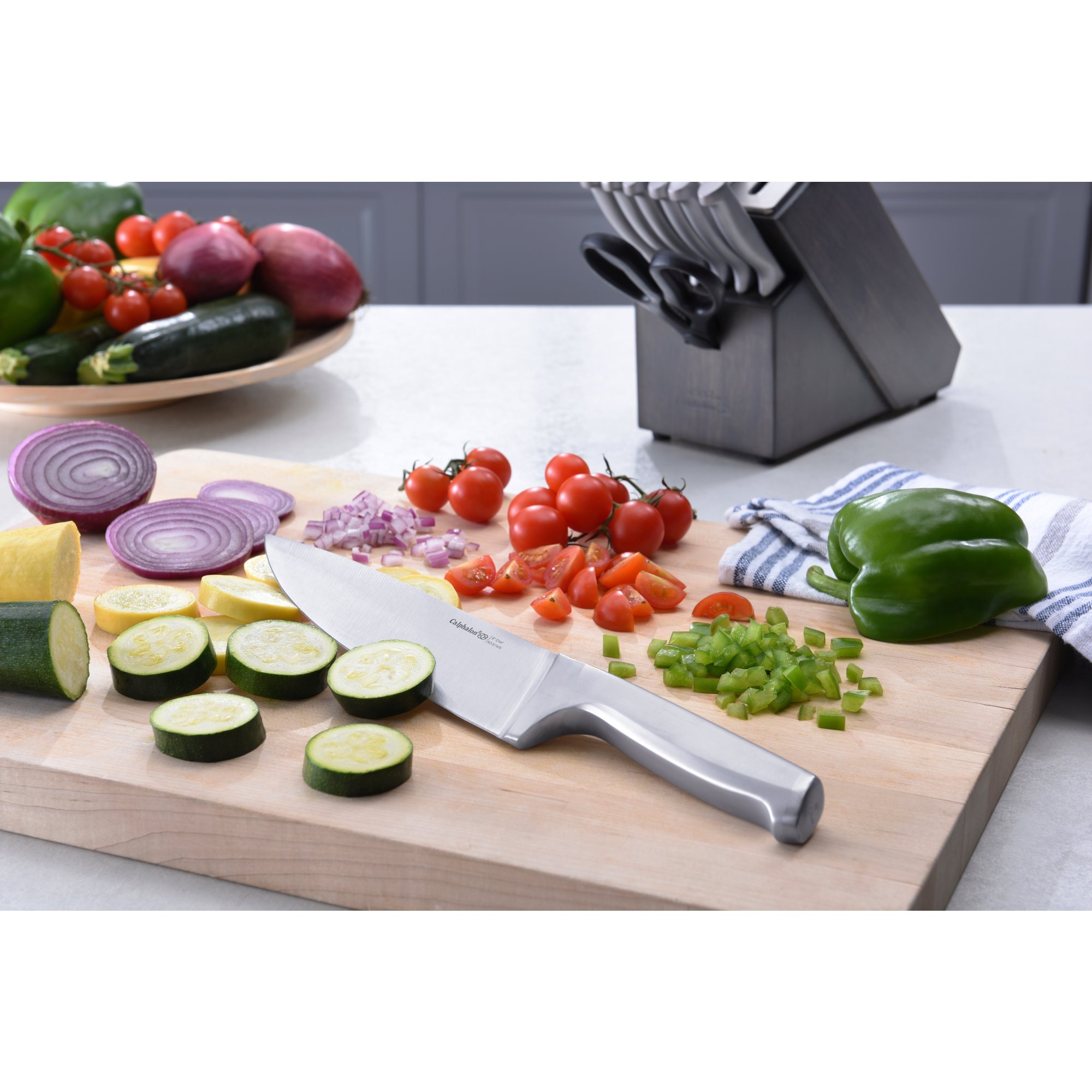https://newellbrands.scene7.com/is/image/NewellRubbermaid/SAP-calphalon-select-stainless-steel-chef-knife-with-food-lifestyle?wid=2000&hei=2000