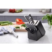 knives in knife block, with chopping board behind it image number 7