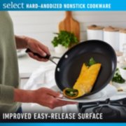 Person cooking with select hard anodized nonstick pan with improved easy release surface image number 3
