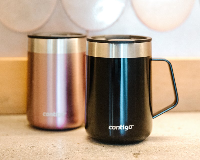 two travel mugs on counter